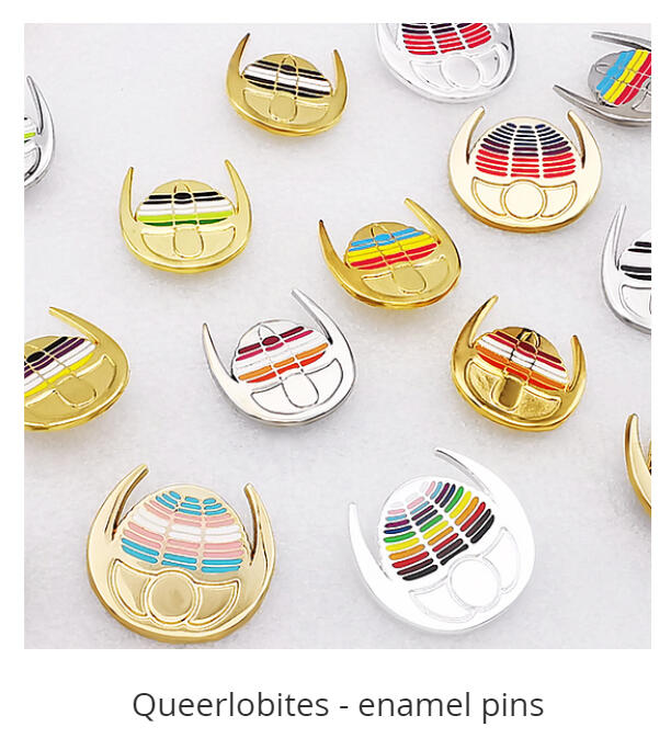 A photograph of numerous trilobite pins. Their segments are colored in the colors of various LGBTQ+ pride flags.