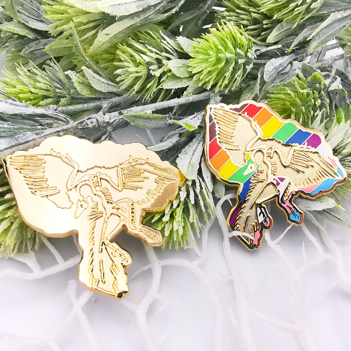 Archaeopteryx lithographica enamel pins featuring LGBT+ Progress Pride Flag.