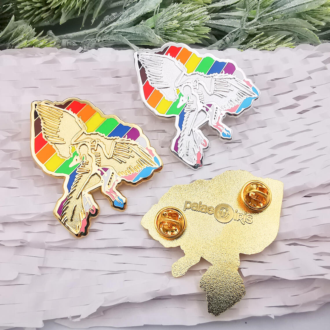 Archaeopteryx lithographica enamel pins featuring LGBT+ Progress Pride Flag.