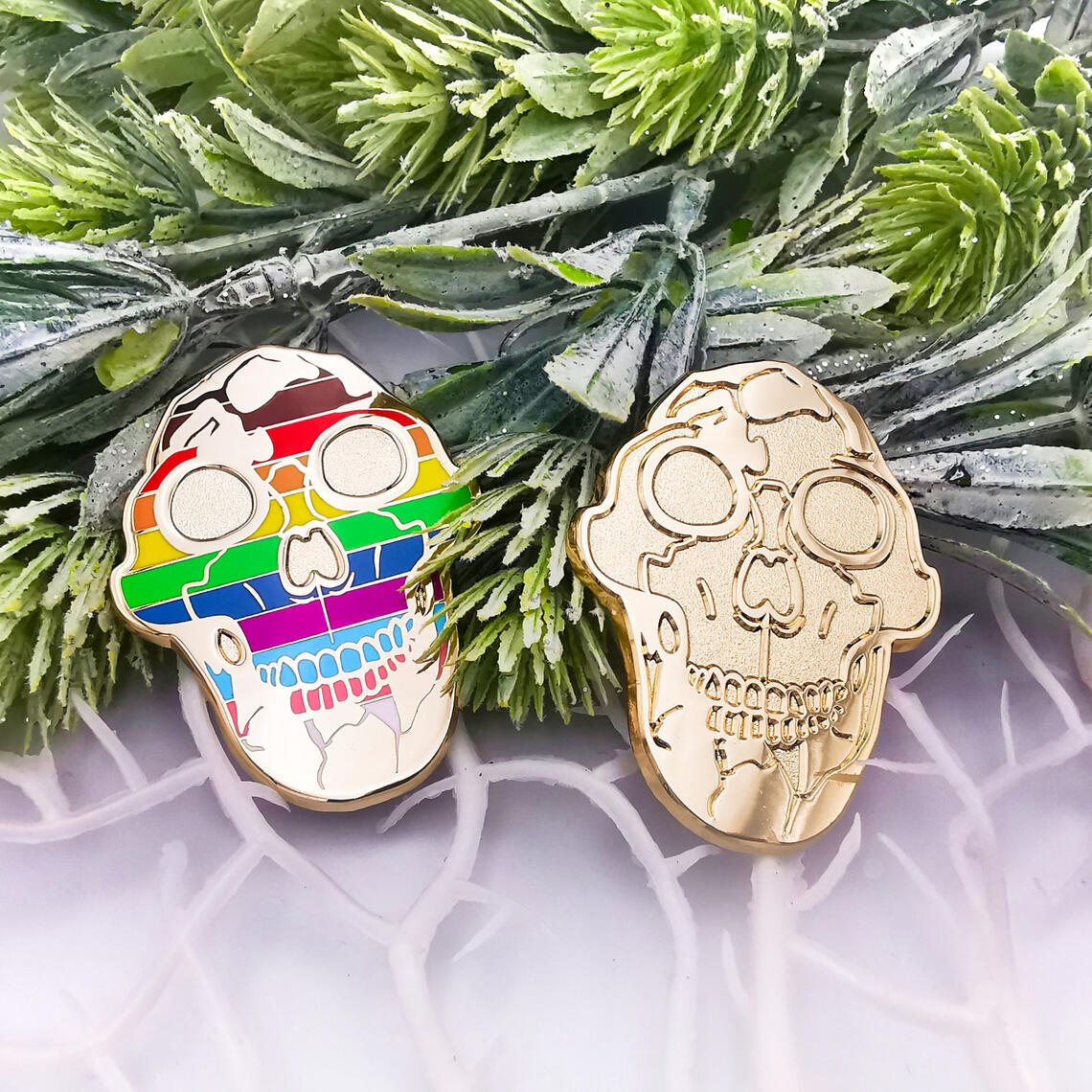 Lucy the Australopithecus enamel pins featuring LGBT+ Progress Pride Flag.